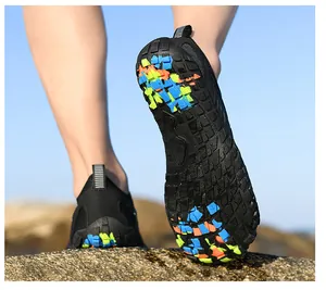 Detailed view of non-slip rubber sole with multi-color blocks on black wading shoes
