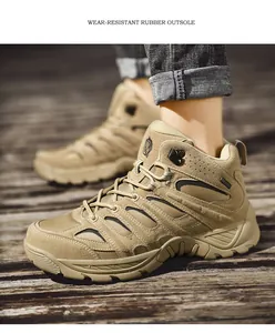 Detail of khaki hiking boots with wear-resistant rubber outsole on outdoor wooden path
