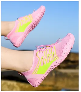 Pink and lime green water shoes with quick-dry mesh and non-slip rubber soles outdoors