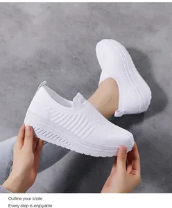 Detail of white knit slip-on sneaker featuring breathable mesh and thick platform sole
