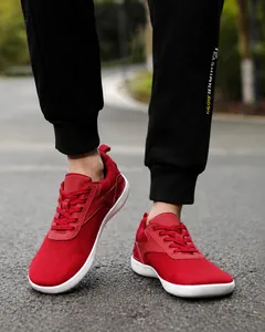 Close-up of red wide toe box barefoot shoes with breathable mesh and hiking shoelaces