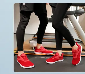 Close-up of red breathable mesh barefoot sports shoes worn on a treadmill for running