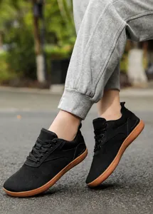 Outdoor view of breathable mesh training shoes with soft brown soles worn on a road