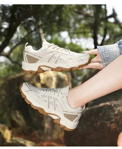 Macro detail of breathable outdoor hiking shoes with anti-slip rubber soles and sport text