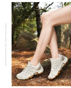 Close-up of stylish beige outdoor hiking shoes with durable rubber soles in a forest setting