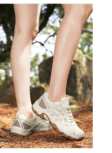 Close-up of breathable beige mesh hiking shoes for women in a natural outdoor setting