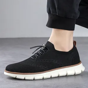 Men's breathable flyknit casual shoes in black with white lightweight soles on a grey background