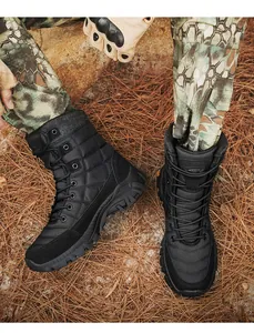 Close-up of tactical boots with thick anti-slip soles on a rugged outdoor terrain
