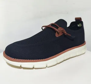 Detail view of breathable black mesh upper and white flexible EVA sole on men's loafers