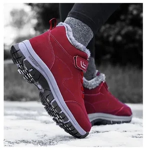 Detail of red snow boots with outdoor anti-slip rubber soles and thick fur lining