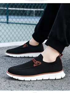 Close-up of breathable black mesh upper and white lightweight thick sole on men's loafers