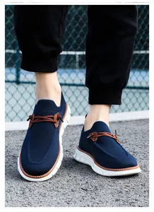 On-foot shot of breathable navy blue mesh slip-on loafers with durable white rubber soles