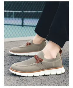 Detail shot of khaki breathable mesh loafers with shock-absorbing white soles on feet