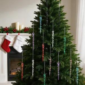 Colorful spiral icicle ornaments hanging on a Christmas tree in a warm indoor setting