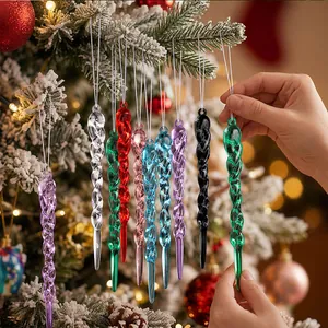 Macro view of colorful spiral acrylic icicle ornaments hanging on a snowy Christmas tree