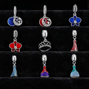 Detailed view of silver charm pendants with colorful enamel and sparkling crystals