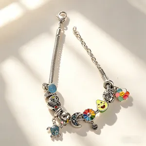 Silver charm bracelet featuring colorful enamel pendants like turtles and sun flowers