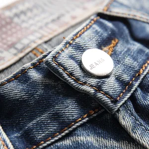 Classic blue washed denim shorts with vintage distressing and branded silver button detail