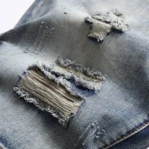 Distressed light blue denim shorts with vintage ripped details and twill texture