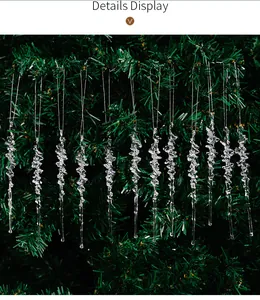 Macro detail of clear acrylic spiral icicle ornaments hanging on a green Christmas tree