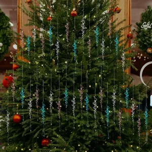 Close-up of glittery acrylic icicle ornaments hanging on a lighted Christmas tree