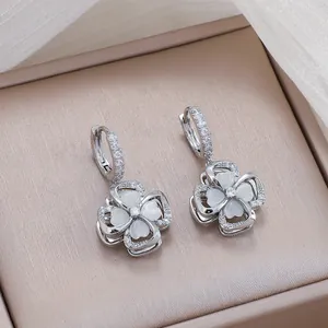 Silver four-leaf clover earrings with sparkling zircon pave and white cat eye stones