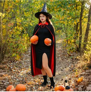 Outdoor shot of a long black witch cloak with red stand-up collar and matching pointed hat