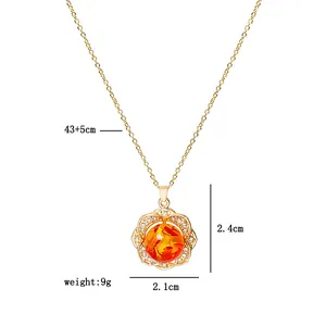 Detail view of gold flower pendant with orange stone and 43+5cm chain measurements
