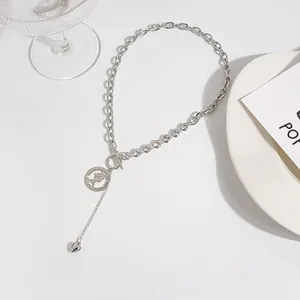 Detail view of silver OT buckle necklace with crystal links and heart coin pendant