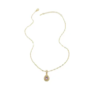 Detail of gold snake chain necklace featuring a purple water drop pendant with crystals