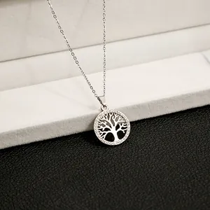 Close-up of tree of life pendant necklace featuring silver plating and white zircons