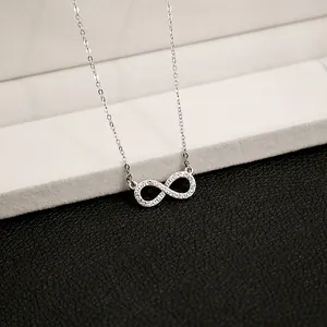 Macro shot of silver infinity pendant necklace with micro-pave cubic zirconia inlay