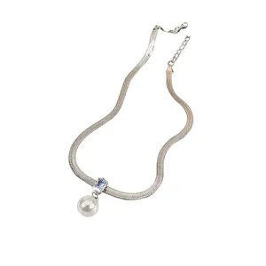 Detail of silver herringbone chain necklace with rectangular zircon and white pearl