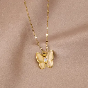 Detailed view of a gold butterfly pendant with opal texture wings on beige satin fabric