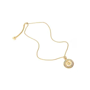 Macro shot of gold octagonal star pendant necklace with sparkling crystal inlay