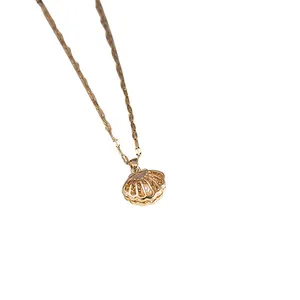 Close-up of gold shell pendant necklace featuring intricate cutouts and sparkling rhinestones