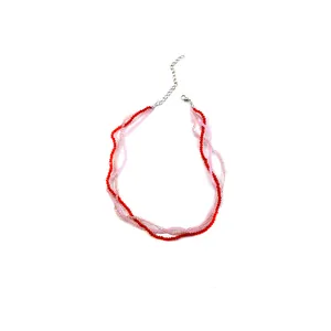 Detail of red and pink multi-layer beaded necklace with metal lobster clasp and chain