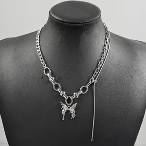 Detail of silver necklace featuring liquid metal butterfly pendant and asymmetric chain
