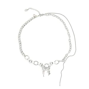 Detail of layered silver snake chain with liquid butterfly pendant and lobster clasp