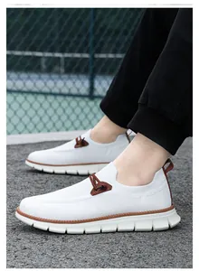 Detail of white mesh breathable men's loafers with brown accents and jagged anti-slip sole