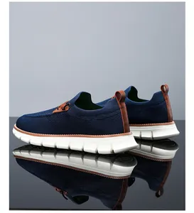 Detailed view of breathable navy knit upper and brown leather heel on men's loafers