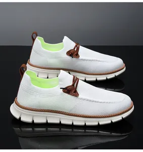 Detail of white knit mesh loafers with brown leather tongue and neon green lining
