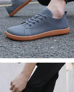 Detail view of breathable grey knit upper and brown non-slip rubber sole of barefoot sneakers