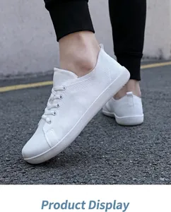 Detail of white breathable knit barefoot running shoes showing texture and soft sole