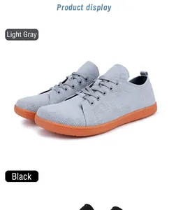 Macro view of light grey knit mesh sneakers with anti-slip orange rubber soles