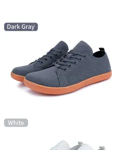 Breathable knitted barefoot shoes in dark grey and white with orange rubber soles