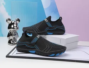 Macro detail of breathable black mesh aqua shoe with blue trim and non-slip rubber outsole
