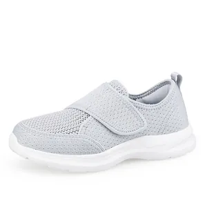 Light grey breathable mesh walking shoes for seniors with easy velcro straps and white sole