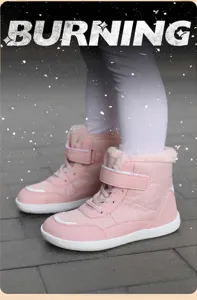 Detail of pink winter snow boots for kids featuring cozy faux fur trim and velcro strap