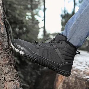 Detail of waterproof snow boots with plush lining and elastic drawstring on tree log